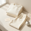 The Emma Lounge Set - bone crewneck and ivory sweatpants folded editorial flatlay