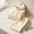 The Emma Off-Duty Set - cream hoodie and sweatpants folded editorial flatlay