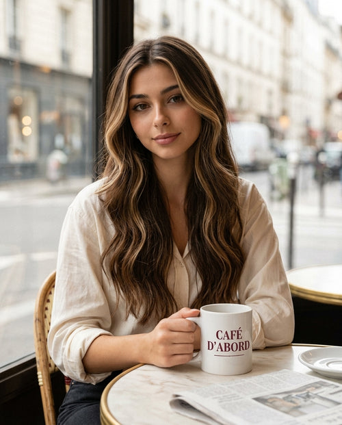 Emma with the Café d'Abord mug at a Paris cafe
