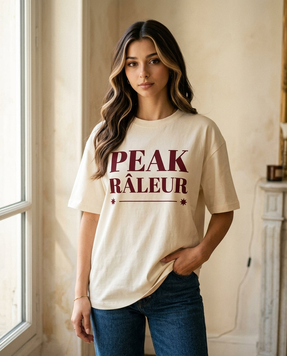 Emma wearing the Peak Râleur tee in soft cream, Paris apartment